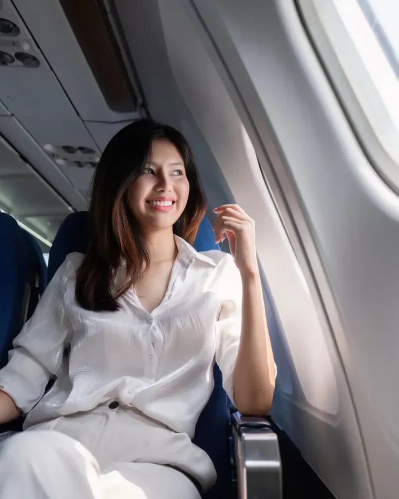 Businesswoman traveling on airplane seat. Concept of business travel and work Businesswoman traveling on airplane seat. Concept of business travel and work