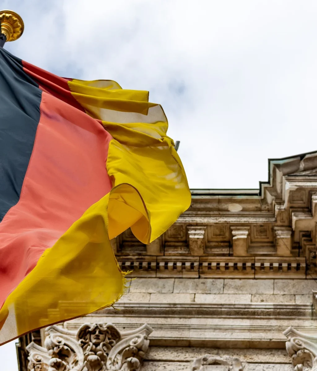 German flag waving in front of the building in Munich, Germany German flag waving in front of the building in Munich, Germany