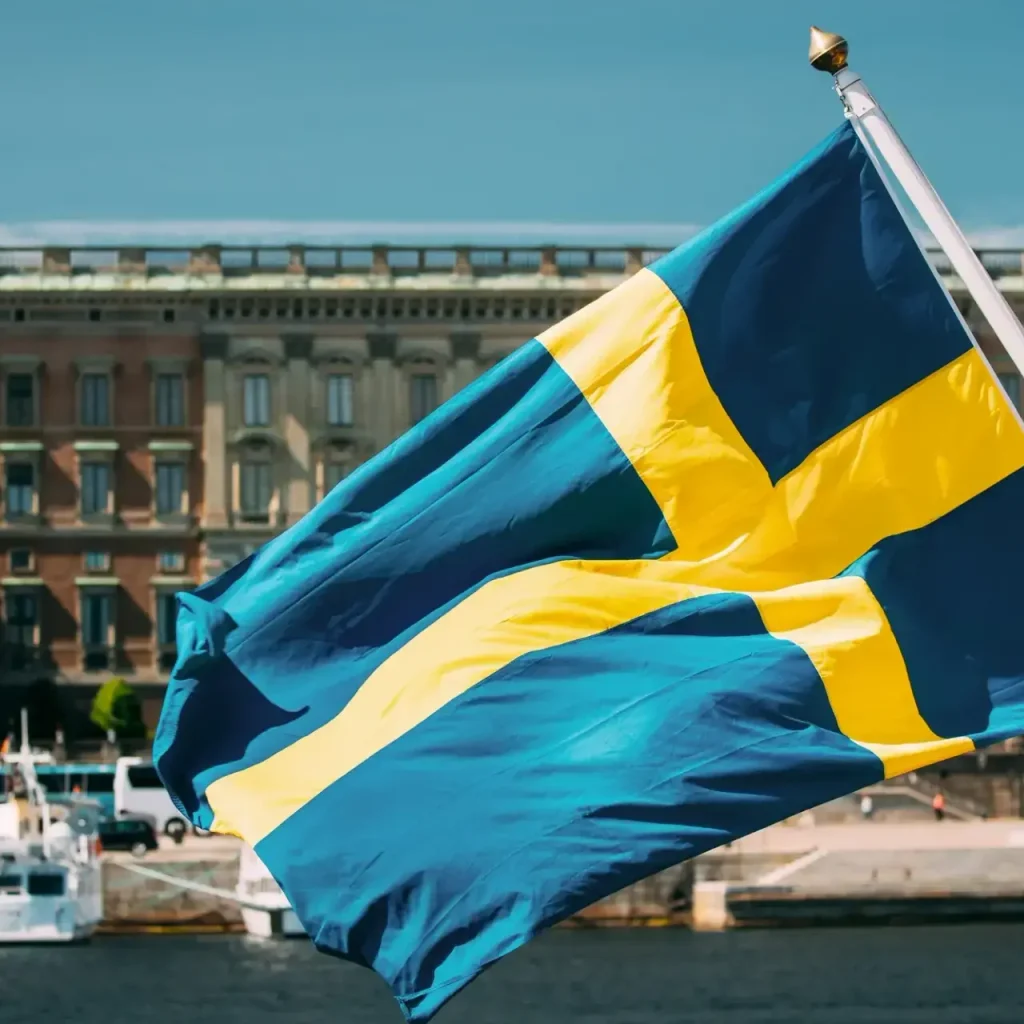 Stockholm, Sweden. Waving Swedish Flag In Stockholm Street. Stockholm, Sweden. Waving Swedish Flag Stockholm, Sweden. Waving Swedish Flag In Stockholm Street. Stockholm, Sweden. Waving Swedish Flag