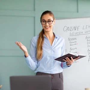 Studying German online. Cheerful female teacher giving online foreign language lesson, using laptop Studying German online. Cheerful female teacher giving online foreign language lesson, using laptop